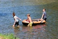 Three kids lay on the river an inflatable plastic raft Royalty Free Stock Photo