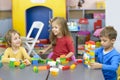 Three Kids Playing at Kindergarten Royalty Free Stock Photo