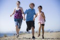 Three Kids Running on Beach Royalty Free Stock Photo