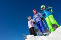 Three kids on ski stand in snow over blue sky Royalty Free Stock Photo