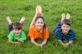 Three kids on spring green meadow Royalty Free Stock Photo