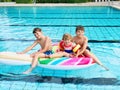 Three kids, two boys and toddler girl splash in an outdoors swimming pool in summer. Happy children, brothers and sister Royalty Free Stock Photo