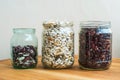 Three kind of sorts of beans in glass jars