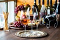 Three kinds of wine on a metal tray with a charcuterie board in behind. Royalty Free Stock Photo