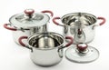 Three kitchen cooking pots with red handles and glass lids Royalty Free Stock Photo