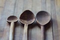 Three kitchen wooden spoons on wooden board Royalty Free Stock Photo