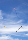 Three kites in blue sky two with tails Royalty Free Stock Photo