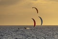 Three kitesurfers at sunset in front of Fremantle beach, Western Australia Royalty Free Stock Photo