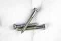 three lag bolts on a white back ground Royalty Free Stock Photo