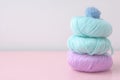 Three large balls of lilac and turquoise color are stacked on top of each other a small blue ball on a pale pink table of pastel Royalty Free Stock Photo