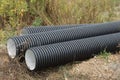 Three large black plastic sewer pipes Royalty Free Stock Photo