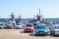 Three large gray modern warships at the pier in the seaport of Varna. View from the parking lot on a sunny summer day. Naval