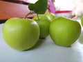 Three large green apples