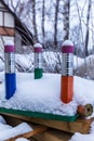 Three large pencils in the snow.