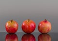 Three large pomegranate on a grey background Royalty Free Stock Photo