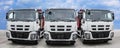 Three large trucks front view on the road