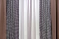 Three-layer curtains in brown fabric, white tulle and goose foot fabric