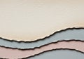 Three layers of textured, torn paper are stacked, each in different hues: beige, light gray, and Royalty Free Stock Photo
