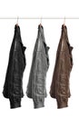 Three leather jackets of different colors are hanging on a hange