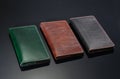 Three leather wallet on a black background
