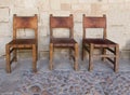 Three leather and wood chairs