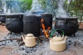 three legged pots cauldron and teapots on the fire cooking outdoors in the african village Royalty Free Stock Photo