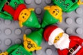 Three Lego elves and Santa Clause against gray baseplate background