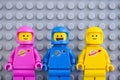 Three The LEGO Movie 2 astronaut minifigures against gray baseplate background