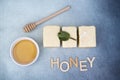 Three lemon cakes with a pot of honey and the word honey Royalty Free Stock Photo