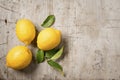 Three lemons and leaves on wood Royalty Free Stock Photo