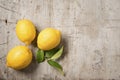 Three lemons and leaves on wood Royalty Free Stock Photo