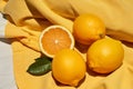 three lemons sit on top of a yellow cloth