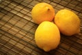 Three lemons on a straw bedding.