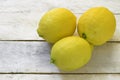 Three lemons on a white wooden table. Royalty Free Stock Photo