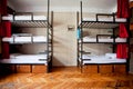 Three-level dormitory beds inside the hostel room for six Royalty Free Stock Photo