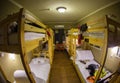 Three-level dormitory beds inside the hostel room for six tourists or students Royalty Free Stock Photo