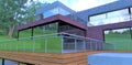 Three-level terrace. Combined wall decoration. Facade board, red-blue brick and slate. Glass and metal railing. Good idea for