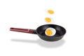 Three levitating fried eggs over frying pan, isolated on white background Royalty Free Stock Photo