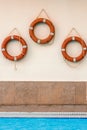 Three lifebuoys are hanging on the wall