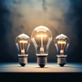 Three light bulbs are lit up and are on a table Royalty Free Stock Photo