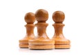 Three light wooden chess pieces alone isolated on white