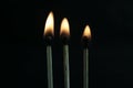 Three lighted matches on a black background, beautiful fire Royalty Free Stock Photo