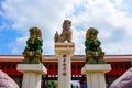 Three Japanese lion statues.