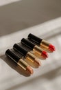 Three Lipsticks Aligned on Window Sill Royalty Free Stock Photo