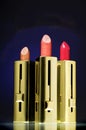 Three lipsticks on a navy blue background Royalty Free Stock Photo
