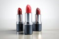 three lipsticks are sitting next to each other on a table Royalty Free Stock Photo