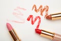 Three lipsticks with swatches on white background Royalty Free Stock Photo