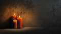Three lit candles casting warm light in a dimly lit room