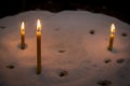 Lit prayer candles standing in sand at a church Royalty Free Stock Photo