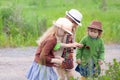 Three little adorable sisters girls exploring nature at the ranch together